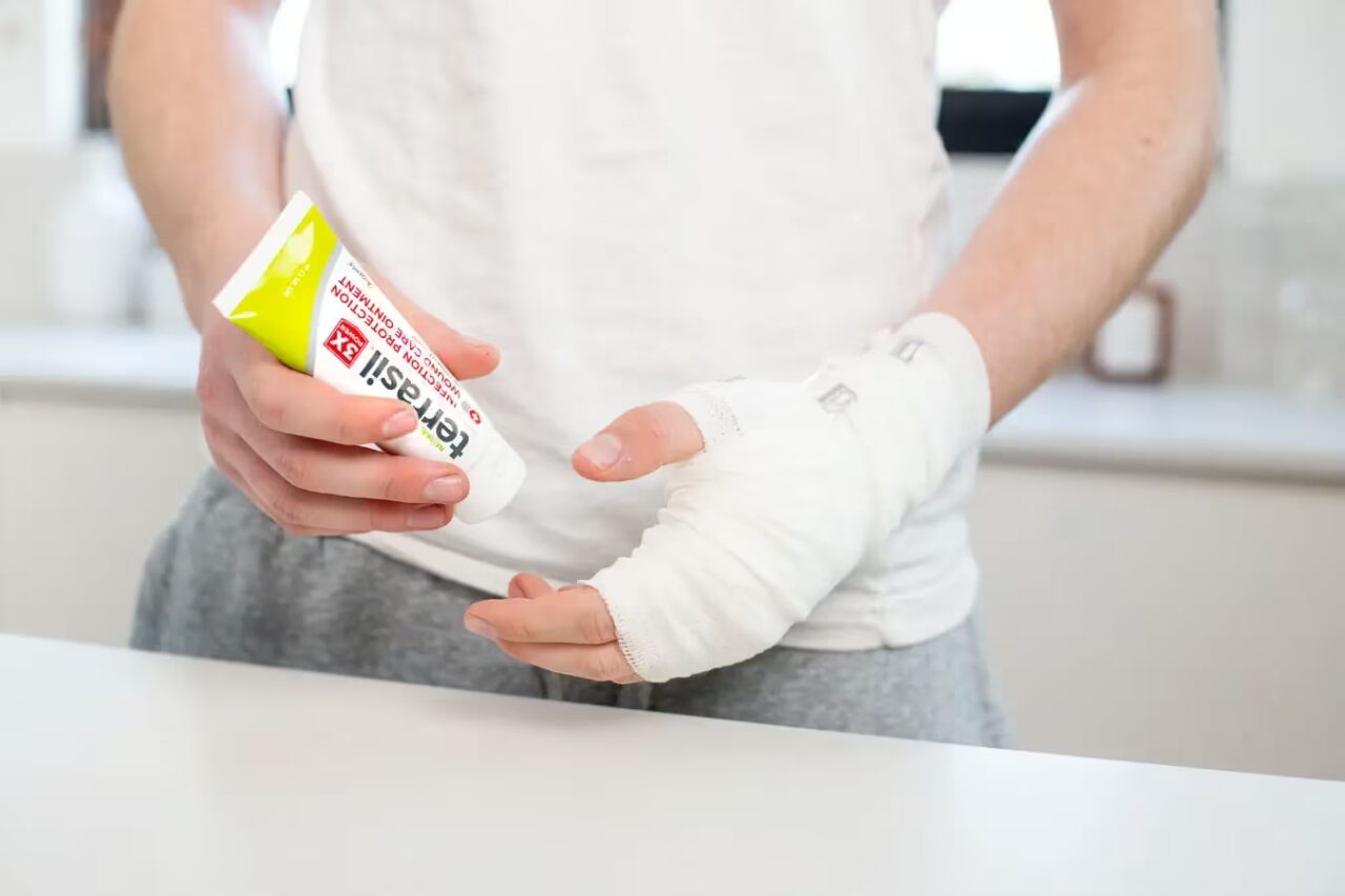 man with bandaged hand applying terrasil wound care ointment