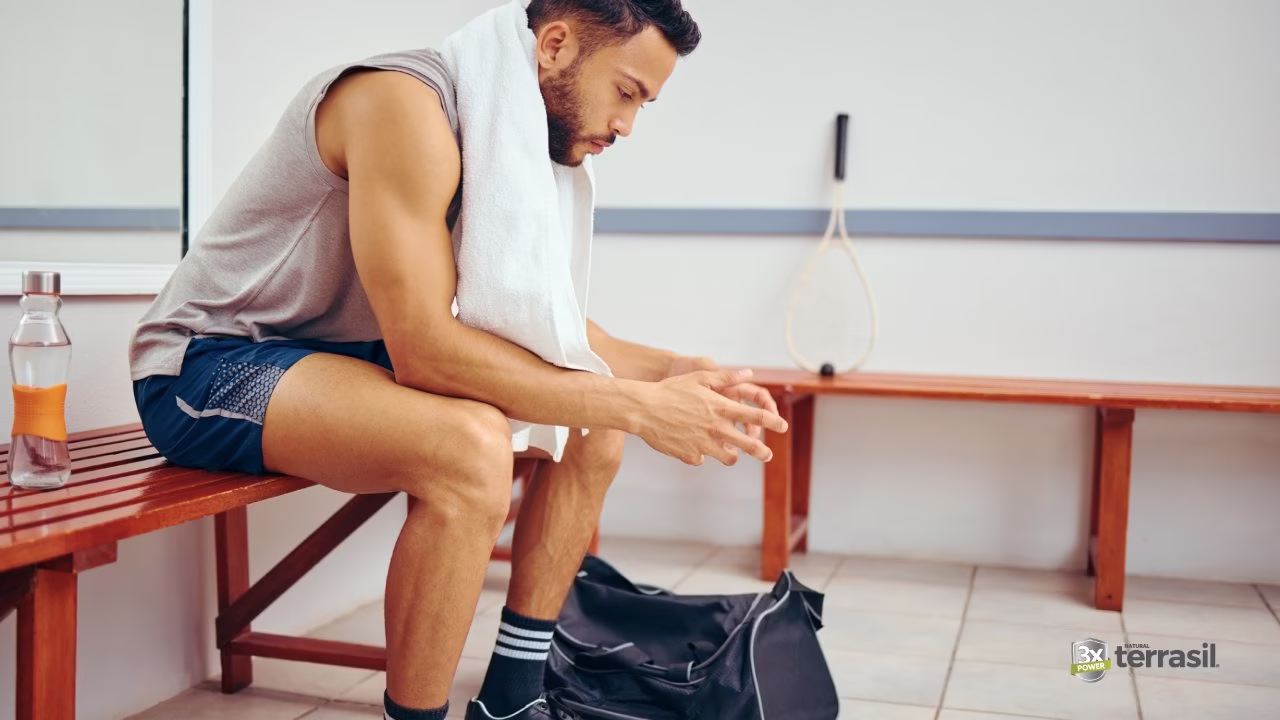 Man sitting on gym bench