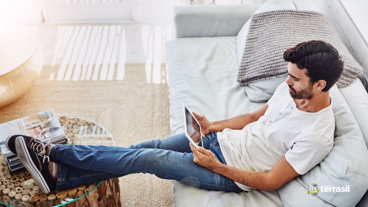 man relaxing on couch with feet up
